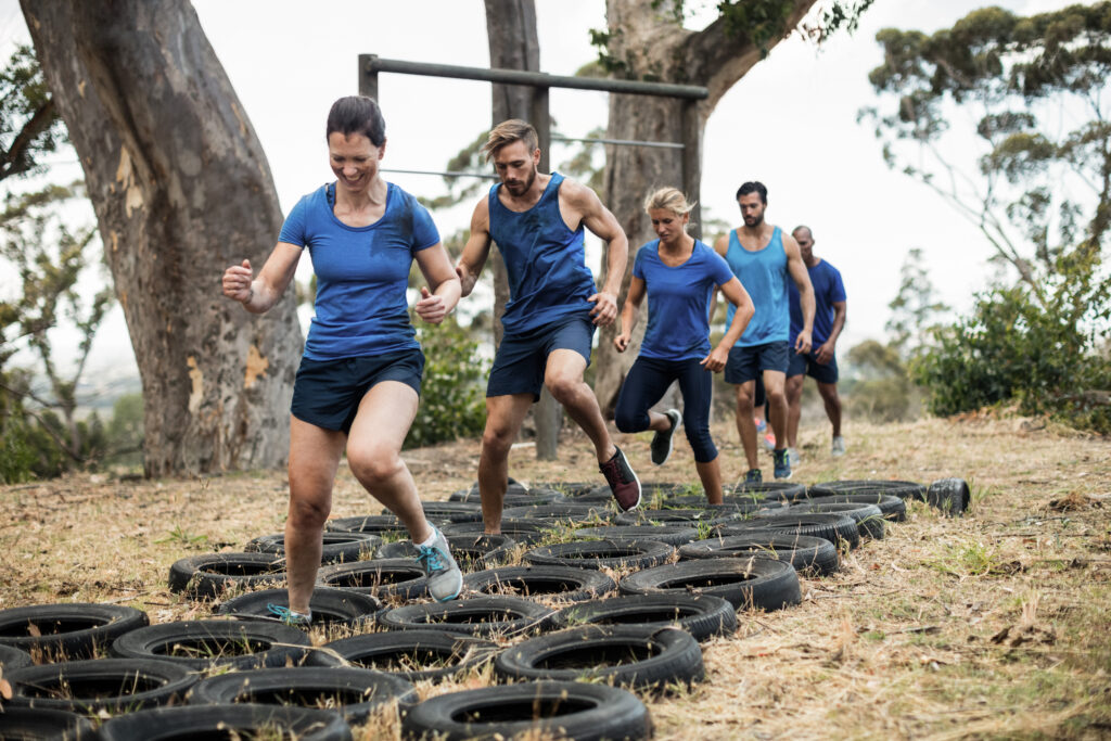 People running through a tyre obstacle course