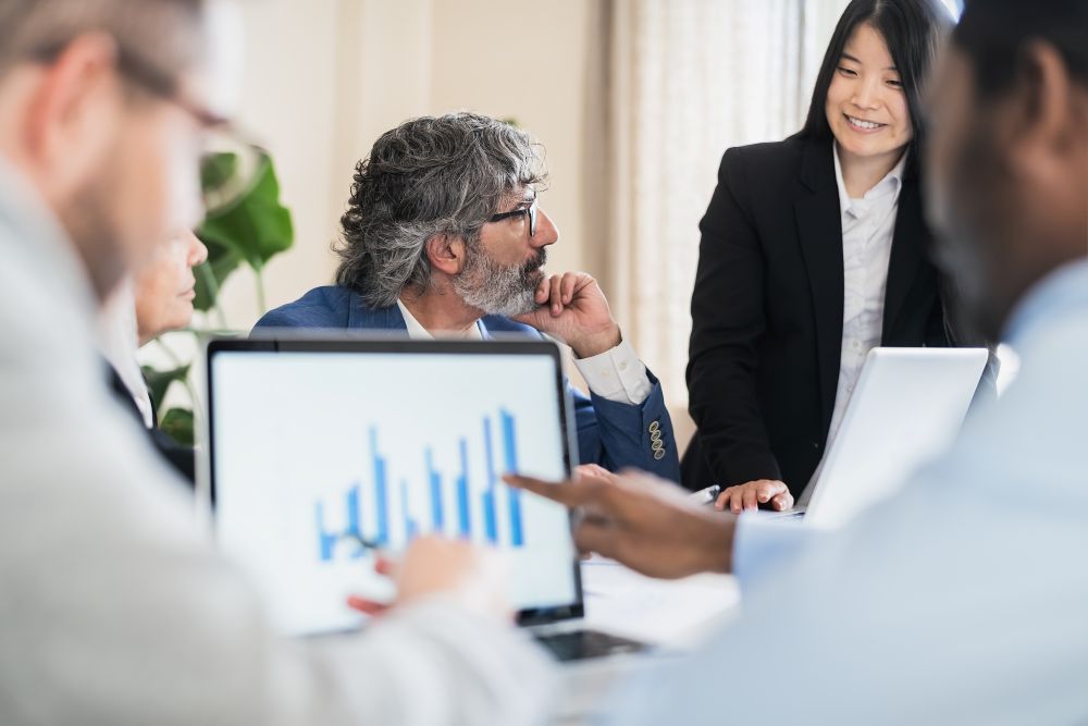 group of people discussing reports